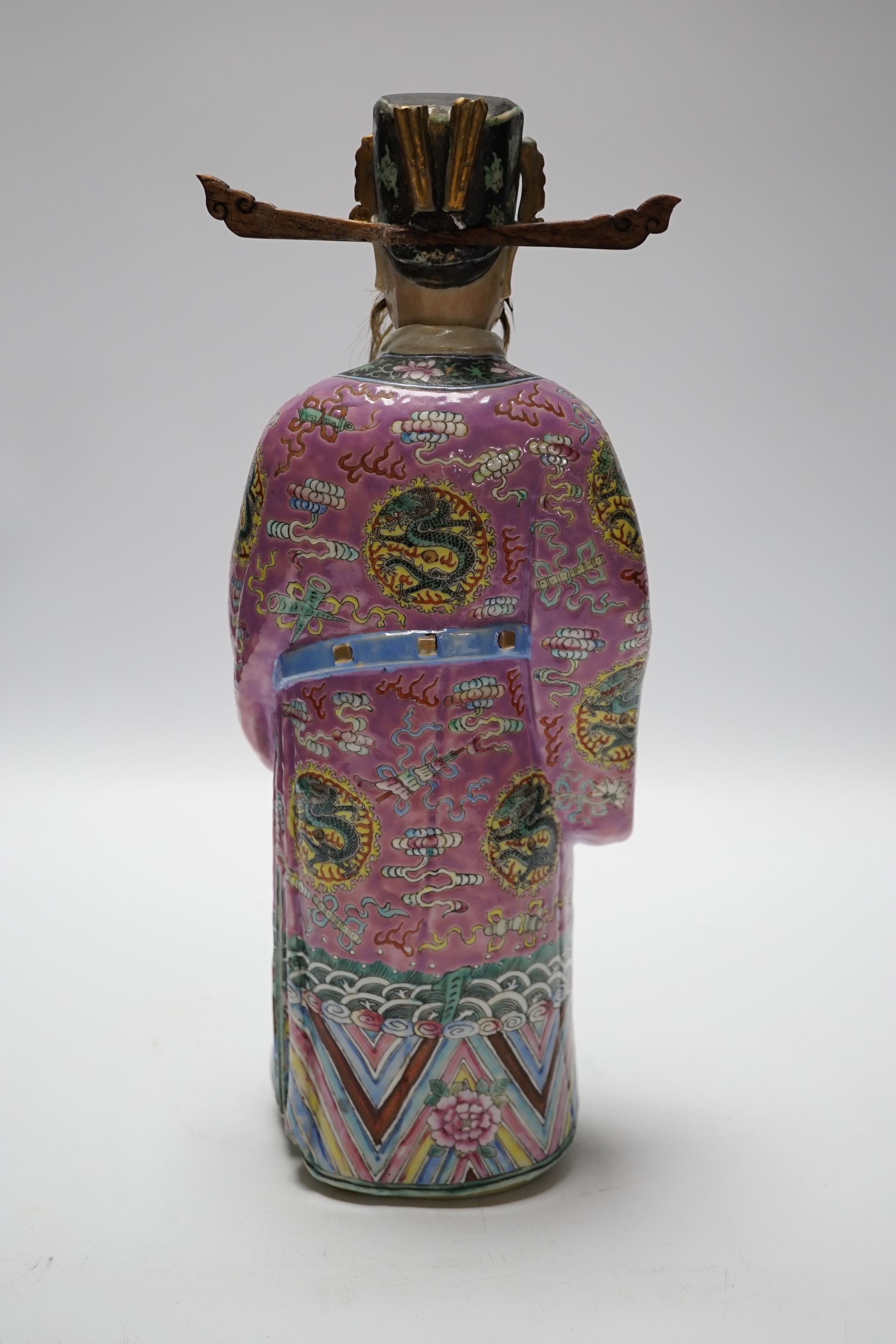An early 20th century Chinese enamelled porcelain figure of an immortal, 31.5 cm high